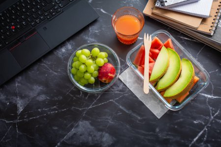 Photo for Healthy snack at office workplace, organic vegan meals from take away lunch box - Royalty Free Image