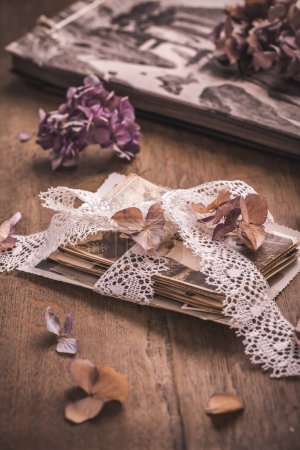 Photo for Memories, antique and old family photos with  dried flowers in vintage style on wooden table - Royalty Free Image