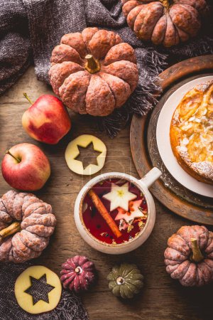 Photo for Herbal tea with fruits and cinnamon with apple pie for Thanksgiving. - Royalty Free Image