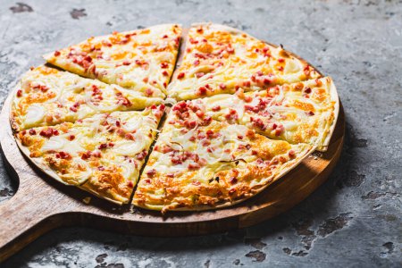 Photo for Traditional French dish tarte flambee with cream cheese, bacon and onions. Flammkuchen from Alsace region. Flame cake. - Royalty Free Image