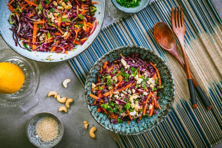 Photo for Red cabbage salad in Asian style with carrots, cilantro, cashew nuts and onions - Royalty Free Image