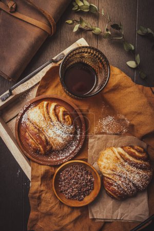 Photo for Cinnamon rolls or Franzbroetchen -  Germany sweet pastry sweet pastry baked with butter and cinnamon,  croissant with cocoa chips - Royalty Free Image