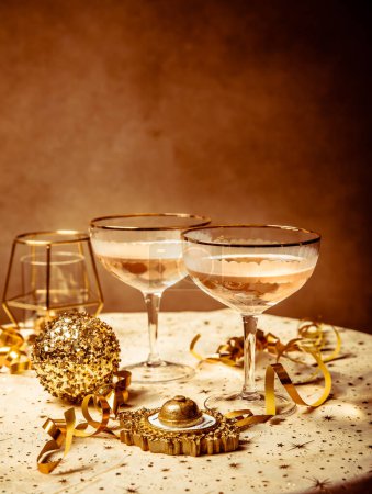 Photo for Happy New Year celebration,  two glasses of champagne, streamers and ornaments - Royalty Free Image