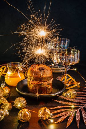 Photo for Traditional Christmas panettone with chocolate, traditional Italian cake for Christmas with sparkler - Royalty Free Image