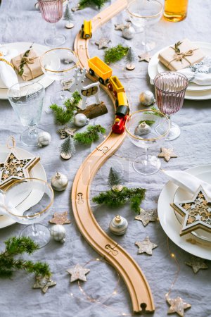 Photo for Festive Christmas place setting with small wooden railway - Royalty Free Image