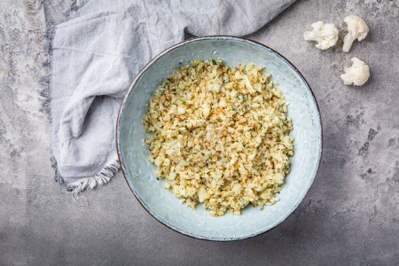 Photo for Roasted  organic cauliflower rice with herbs - paleo and ketogenic diet concept - Royalty Free Image