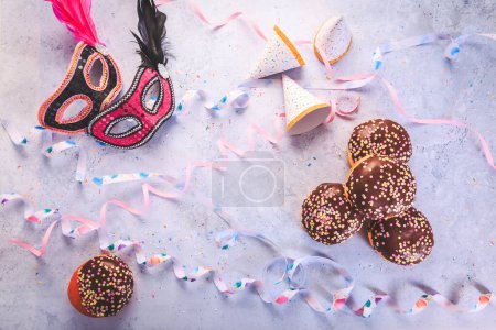 Photo for Carnival food. German Krapfen or donuts with streamers and confetti. Traditional Berliner for carnival and party. - Royalty Free Image