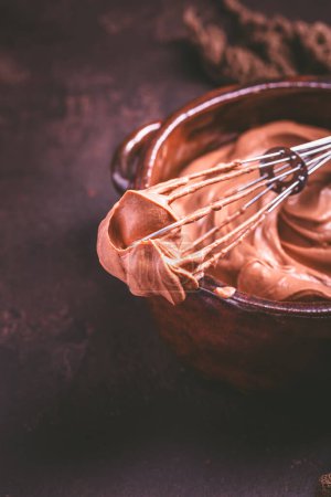 Photo for Chocolate cream cheese mousse in a bowl with whisk, preparing healthy homemade sugar free snack - Royalty Free Image