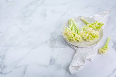 Photo for Raw organic baby stick cauliflower in a bowl. - Royalty Free Image
