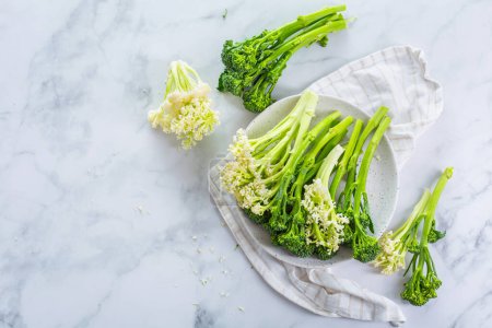 Photo for Fresh raw green bimi, broccolini and baby stick cauliflower in a bowl - Royalty Free Image
