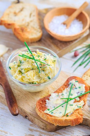 Photo for Homemade garlic butter with chives and fresh roasted baguette with salt - Royalty Free Image