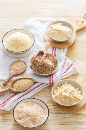 Photo for Assortment of various gluten free flour,  without carbohydrate (almond and coconut flour, psyllium husk powder, rough-ground flaxseed flour) - Royalty Free Image