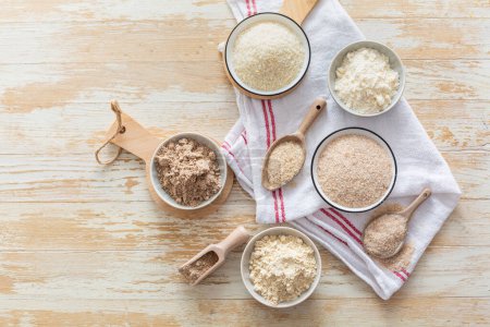 Photo for Assortment of various gluten free flour,  without carbohydrate (almond and coconut flour, psyllium husk powder, rough-ground flaxseed flour) - Royalty Free Image