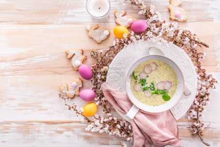 Photo for Vegetable soup with zucchini, cauliflower and radish for Easter with colorful eggs - Royalty Free Image