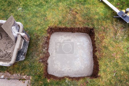 Photo for Pouring concrete slab for shed foundation for covering open terrace or patio - Royalty Free Image