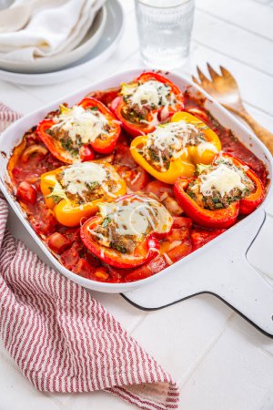 Photo for Stuffed peppers, filled with minced meat, feta cheese, ramson and tomatoes in casserole - Royalty Free Image