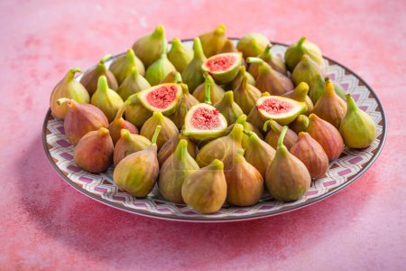Photo for Organic ripe sweet figs on a plate.. Healthy mediterranean fig fruits - Royalty Free Image