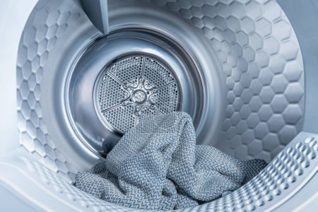 Photo for Inside of tumble dryer with clean laundry - new generation of heat pump dryer, household concept - Royalty Free Image