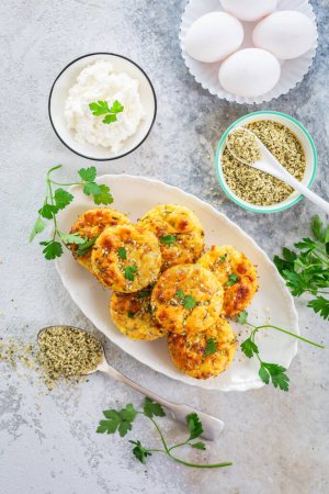 Photo for Homemade egg and zucchini muffins with feta cheese, savory courgette with ingredients - Royalty Free Image