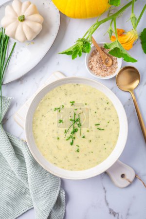 Photo for Spring white creamy zucchini soup with herbs - Royalty Free Image