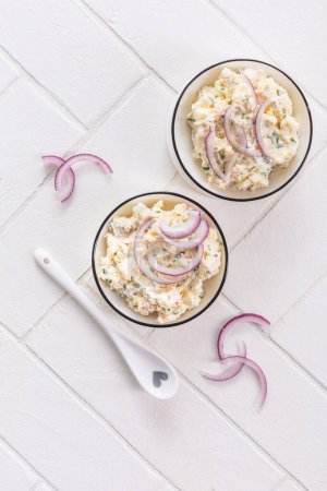 Photo for Fish and egg spread, paste or salad with red onions - Royalty Free Image