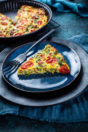 Photo for Homemade frittata with spinach, curd cheese, bacon, onion and green onions - Royalty Free Image