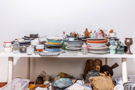 Photo for Kitchen clutter, utensils and kitchenware on a table. Concept of tidying and decluttering - Royalty Free Image