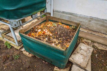 Photo for Compost bin in a garden, using kitchen and green waste to prepare organic fertilizer - Royalty Free Image