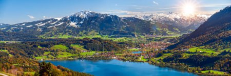Photo for Panoramic landscape with lake, mountain range and sun on sky - Royalty Free Image