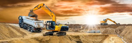 Téléchargez les photos : Excavatrice travaille et creuse sur le chantier de construction - en image libre de droit