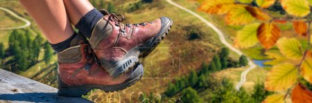 Photo for Walking boots while trekking tour in mountains at autumn - Royalty Free Image