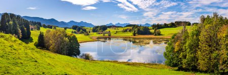 Foto de Panoramic landscape with lake at springtime in front of mountain range - Imagen libre de derechos