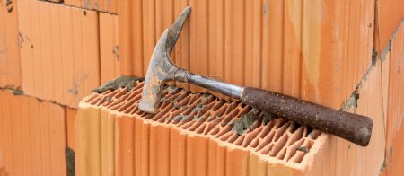 Photo for Bricklayer at work at new house in construction - Royalty Free Image