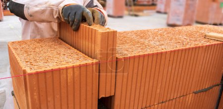 Photo for Bricklayer at work at new house in construction - Royalty Free Image