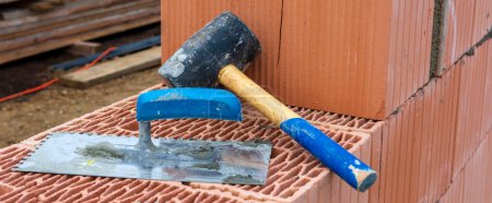 Photo for Bricklayer working at new built home - Royalty Free Image