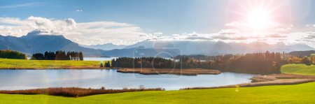 Photo for Panoramic landscape in region Allgaeu at springtime with beautiful lake and alps mountain range in backround - Royalty Free Image