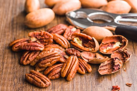 Peeled pecan nuts on the wooden table.