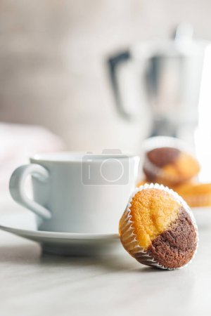 A variety of golden-brown muffins on a white table, inviting a taste.