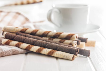 Assorted Chocolate and Vanilla Cream Filled Wafer rolls on a white table.