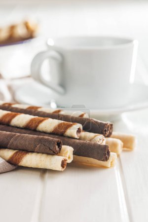 Assorted Chocolate and Vanilla Cream Filled Wafer rolls on a white table.