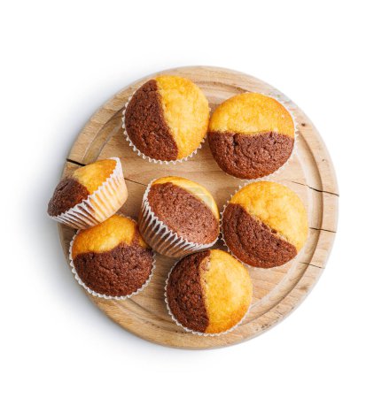 Close Up of a Muffins on cutting board isolated on a white background.