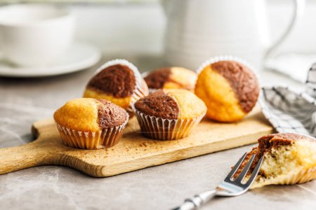 Close Up of a Muffins on cutting board on a kitchen table