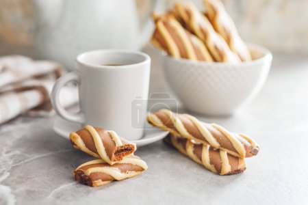 Classic Striped Cookies and coffee cup on a kitchen table.