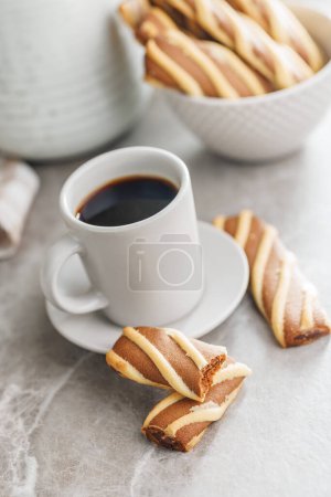 Classic Striped Cookies and coffee cup on a kitchen table.