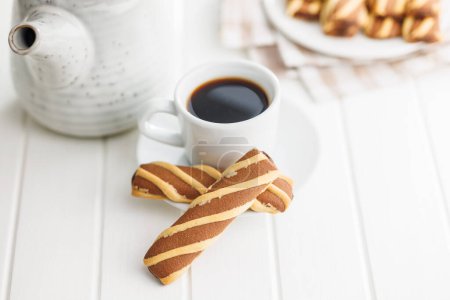 Classic Striped Cookies and coffee cup on a white table.