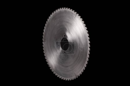 Photo for Massive circular steel saw blade isolated on a black background. Industrial machine part with copy space - Royalty Free Image