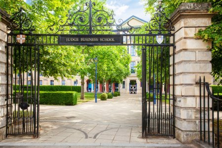 Photo for University of Cambridge Judge Business School in Cambridgeshire England. Open gates leading into the building which used to be an old hispital building now known for its floating staircases and balconies - Royalty Free Image