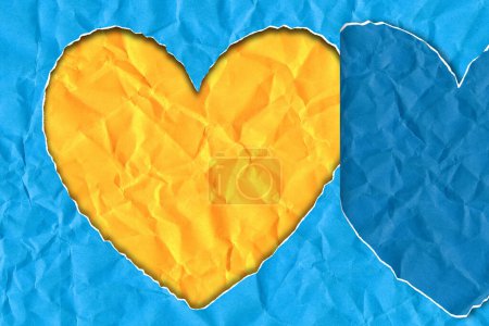 Torn paper in the shape of a heart in the colors of the Ukrainian flag