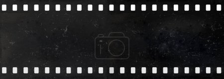 Long strip of old and dirty celluloid film with dust and scratches isolated on background
