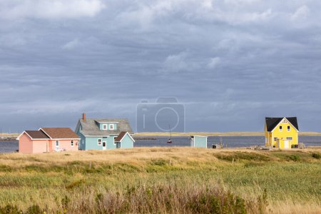 The colourful houses and fishing boats of Havre Aubert, Magdalen Islands, on the gulf of St Lawrence in Canada.